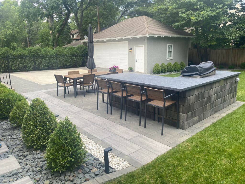 custom L Shape outdoor kitchen area with large stone pavers - Yellow Brick Road Pavers & Landscapes LLC